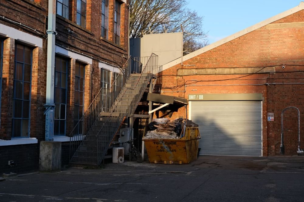A renovated factory now serves as a warehouse, highlighting a junk removal service based in Tampa, FL.